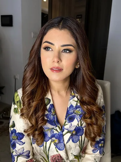 A portrait of Shreya Ghodawat. Her makeup is subtle and sophisticated, with soft brown tones on the eyes and a natural lip color.
