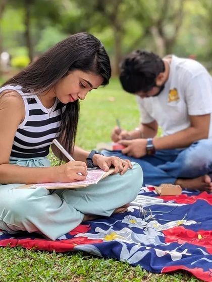 Young artists enjoying a quiet afternoon of drawing and sketching on the grass at Cubbon Park. Art is for everyone.
