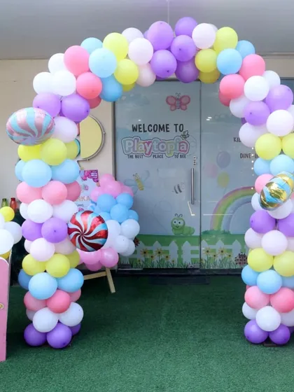 The party starts the moment you arrive! We love creating a grand entrance, like this sweet Candyland theme, complete with a colorful balloon arch and giant popcorn boxes to welcome your guests to a world of fun.