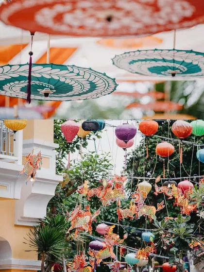 A collage of hanging decorations at a vibrant mehendi. The decor includes colorful lanterns, dragon-shaped hangings, and traditional painted umbrellas, creating a festive and eclectic look.