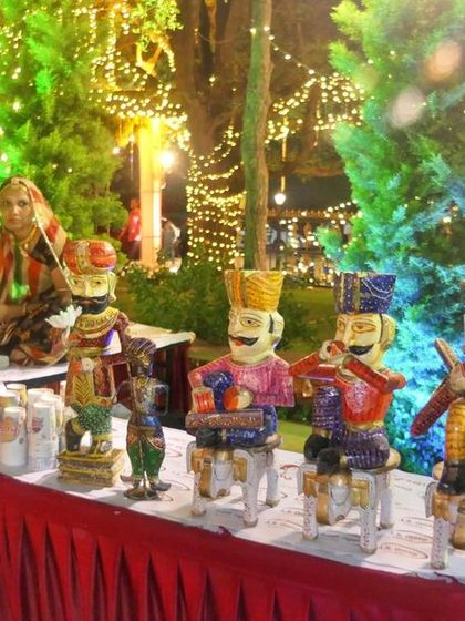 A closer look at the decorative puppets and the traditional buttermilk pot at one of our themed food stations. These details help create an authentic village fair atmosphere.