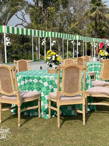 Guest dining tables at the sports party featured green and white checkered tablecloths and football-themed centrepieces.