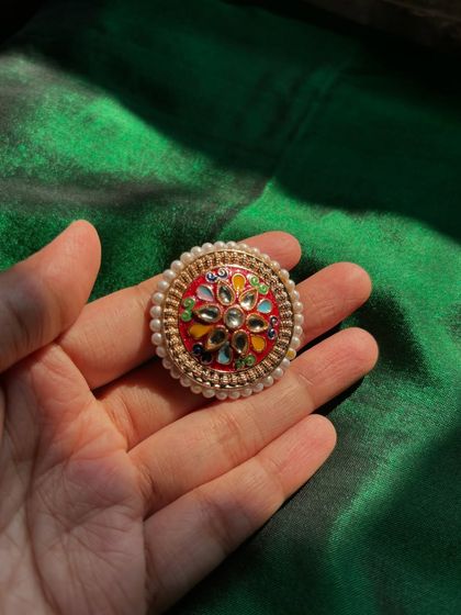 A vibrant, hand-painted Meenakari statement ring. This adjustable ring is a piece of art and can add a pop of colour to any traditional outfit.