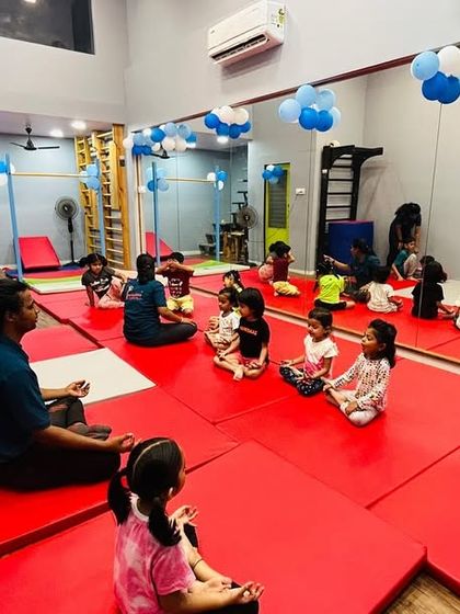 A moment of focus during one of our kids' fitness sessions. Here, children are seated on safety mats as they listen to instructions, a key part of our classes that helps develop discipline and listening skills alongside physical activity.