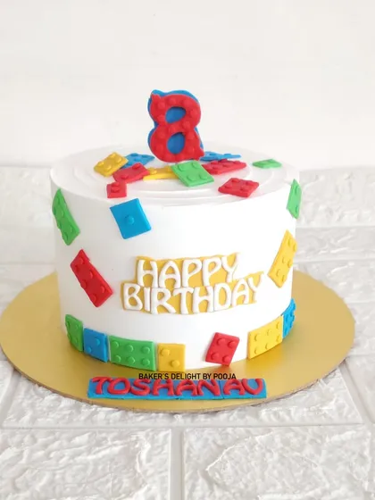 Building a great birthday! This playful LEGO cake for an eighth birthday is decorated with colorful, edible fondant bricks.