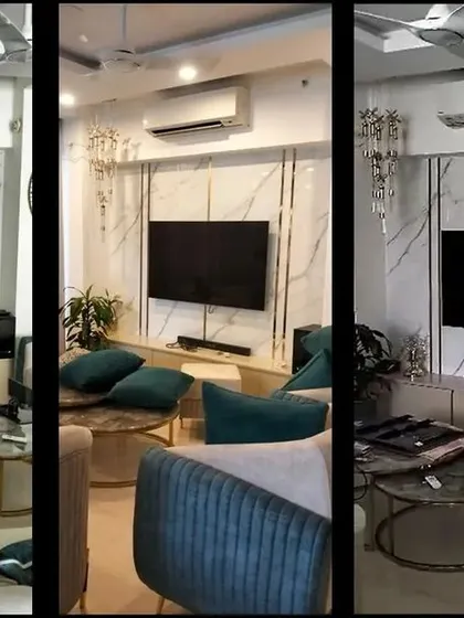 The final outcome of the living room, where the TV wall now stands as a seamless feature. The turquoise chairs and plush sofas add a pop of color to the sophisticated space.