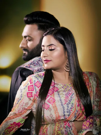 A close-up portrait from the pre-wedding shoot. The makeup features a pop of pink on the lips and soft eyes, complementing her colorful printed top.