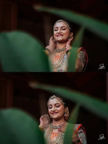 A creative shot through foliage, creating a natural frame for the bride's happy expression. This technique adds depth and an artistic touch to our portraits.