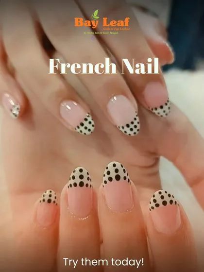 A playful and chic twist on a classic. These almond-shaped nails feature a modern French manicure with a fun black polka dot pattern on the tips for a unique style statement.