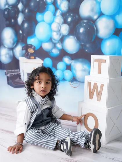 Posing with the "TWO" blocks, this little dude is proudly celebrating his second birthday in style.