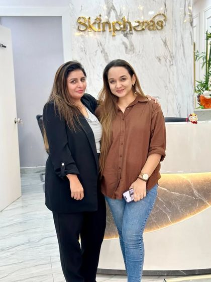 A photo of our founder with a happy client at the clinic reception. We pride ourselves on building lasting relationships based on trust and excellent results.