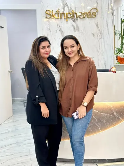 A photo of our founder with a happy client at the clinic reception. We pride ourselves on building lasting relationships based on trust and excellent results.