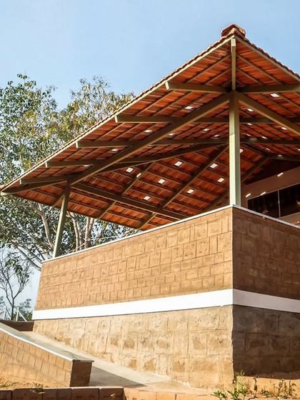 Here, the repeating pattern of the Mangalore tiles on the roof and the texture of the earth block wall create a pleasing visual rhythm. This demonstrates how simple, repeated elements can come together to form a cohesive and beautiful architectural design.