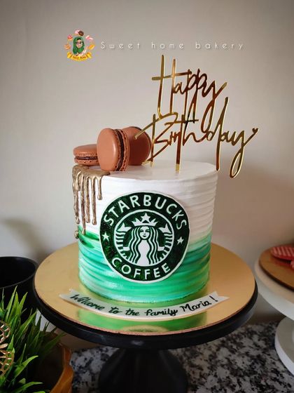 For the Starbucks lover, a cake that looks as good as their favorite coffee tastes. This design features the iconic green and white logo, a stylish gold drip, and is topped with delicious macarons.