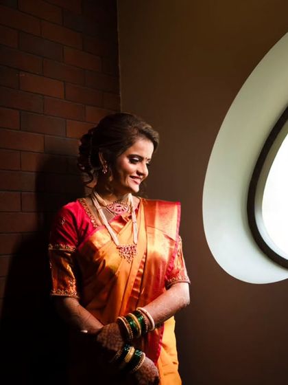 An artistic bridal portrait using a circular window to create a beautiful, dramatic light.