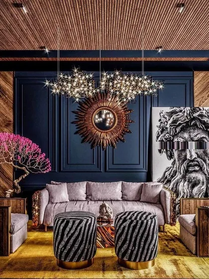 We draw inspiration from bold, maximalist designs that layer color, texture, and art. This image reflects our love for creating dramatic spaces with statement pieces like a sunburst mirror, a modern art canvas, and a striking chandelier against a dark, paneled wall.