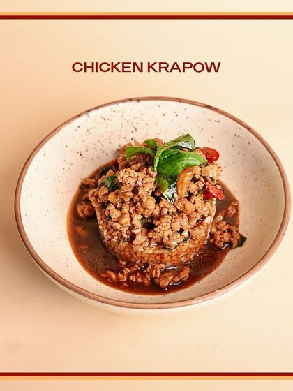 A serving of my Chicken Krapow, a popular Thai street food dish. It features minced chicken stir-fried with holy basil, chili, and garlic for a fragrant and spicy kick.