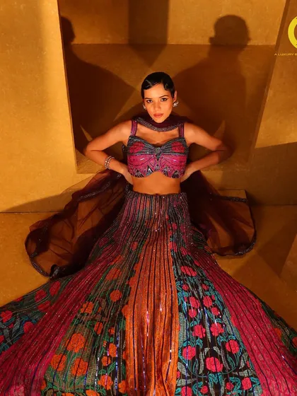 A perfect blend of vibrant hues and meticulous craftsmanship. This multi-colored sequin and floral lehenga is a true showstopper from the 'Samah' collection.