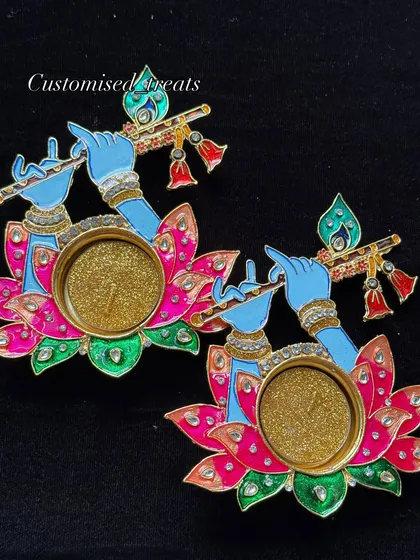 Light up your sacred space with these Krishna-themed T-light candle holders. The design features Kanha Ji playing his flute on a lotus, adding a warm, divine glow to your mandir or home decor.