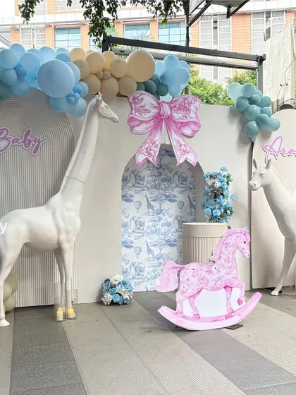Another angle of the stunning Dior-inspired baby shower backdrop, showcasing the balloon arch and whimsical animal props.
