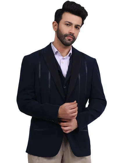 A close-up of the model in the navy suit, highlighting the texture and fit of the jacket.