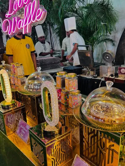 A close-up of the waffle toppings and display, including jars of sprinkles and beautifully presented pre-made waffles.