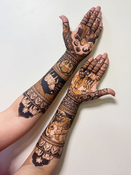 This design features Radha Krishna figures on the arms, a popular choice for brides. The dark, bold application makes the figures stand out beautifully.