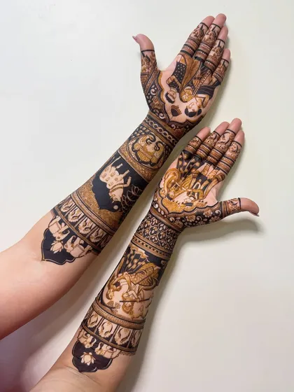 This design features Radha Krishna figures on the arms, a popular choice for brides. The dark, bold application makes the figures stand out beautifully.