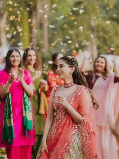 The bride makes a joyful entrance to her Mehendi party, surrounded by her dancing friends and a shower of confetti. I design entries that are full of life and set the tone for the event.