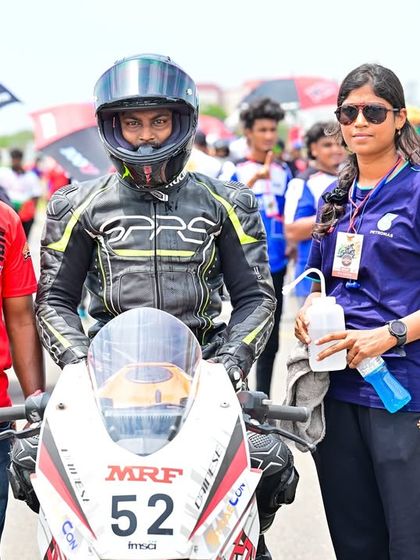 Swaroop with his support crew on the grid. A rider's success is a team effort, and we ensure our racers have the backing they need.