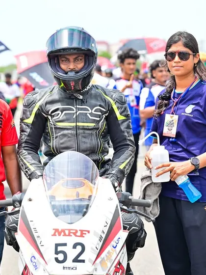 Swaroop with his support crew on the grid. A rider's success is a team effort, and we ensure our racers have the backing they need.