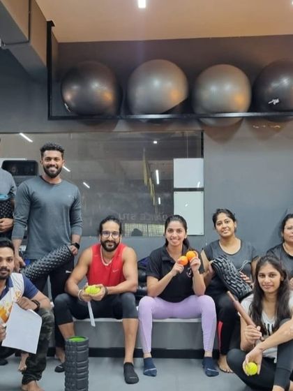 Students and their trainer pose with foam rollers and massage balls after a successful workshop on mobility and recovery.