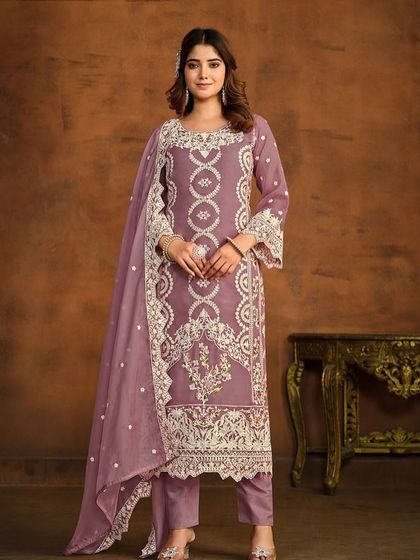 This mauve organza Anarkali is soft and dreamy. The detailed thread embroidery on the hem and sleeves gives it a delicate, handcrafted feel.