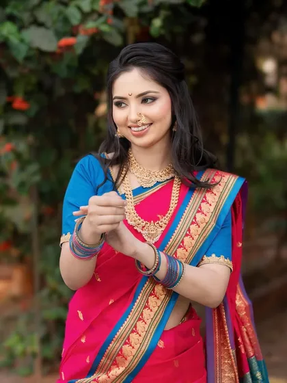 A happy and candid shot of our bride. Her hair is styled in loose waves with a half-updo, perfect for a more relaxed yet traditional wedding function.