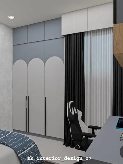 A view of the wardrobe in the teenager's room, featuring modern arched door designs. The grey and white color scheme is sophisticated and timeless.