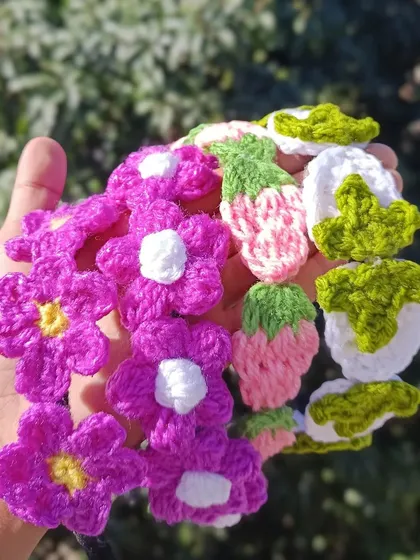 A closer look at the detail on the custom flower and strawberry hairband appliques before they are attached to the bands.