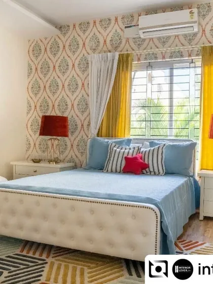 Color makes a kid's room come alive. This vibrant bedroom uses a playful mix of patterns and bright colors, from the geometric rug to the bold wallpaper and sunny yellow curtains, creating a cheerful and energetic space.
