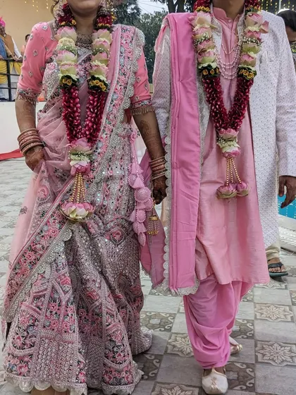 We also offer traditional outfits for wedding ceremonies. This couple is coordinated in beautiful pink Indian wear, available for rent.
