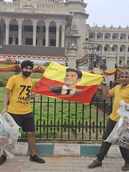 Two of our members holding up collected litter and a flag celebrating Karnataka. Plogging, or picking up trash while jogging, is a core part of our community service initiatives.