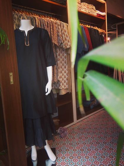 A peek into my studio closet where finished creations are ready for clients. On display is a classic black kurta set, showcasing the simple elegance that is a hallmark of my designs.