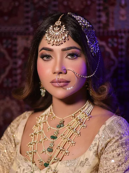 A full portrait of the Heeramandi-inspired look, showcasing the layered pearl necklaces and the soft, elegant makeup.