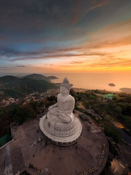 A panoramic view of the Big Buddha statue, capturing the stunning landscape of Phuket and the ocean beyond.