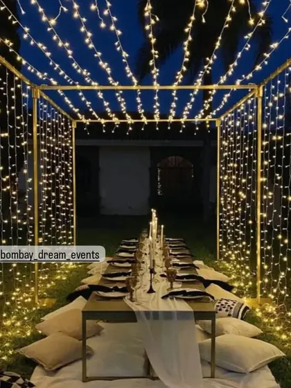 I transform outdoor spaces into magical dining experiences. This fairy light canopy creates a starlit effect for an intimate dinner party, perfect for birthdays or anniversaries under the open sky.
