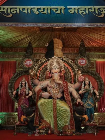 The beautifully decorated pandal for Sanpada Cha Maharaja, showing the idol in its full glory within the festive setup.