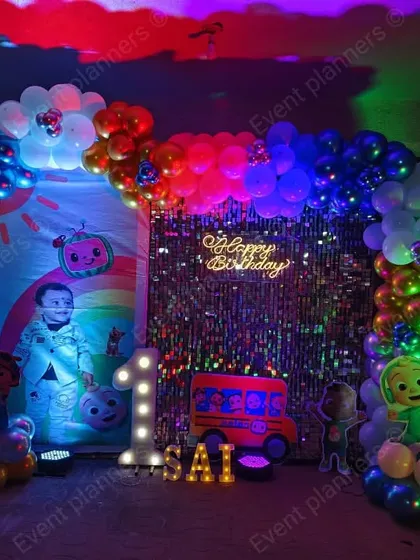 The full view of the Cocomelon home party with a sequin backdrop.