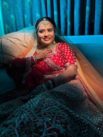 A full-length shot showing the bride's complete look. The vibrant lehenga and elegant makeup create a stunning visual.