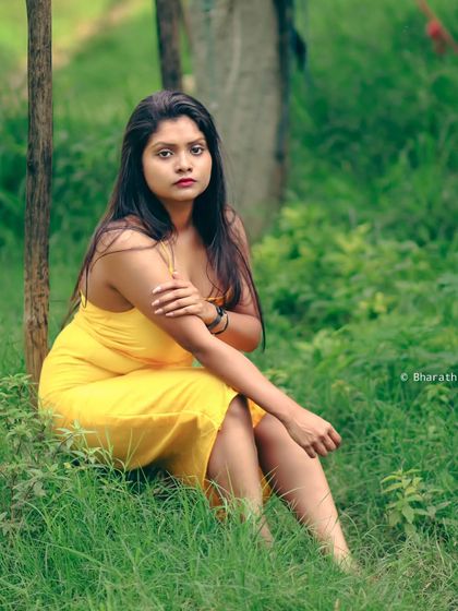 Another angle of the seated portrait in the grass, capturing a different expression and mood.