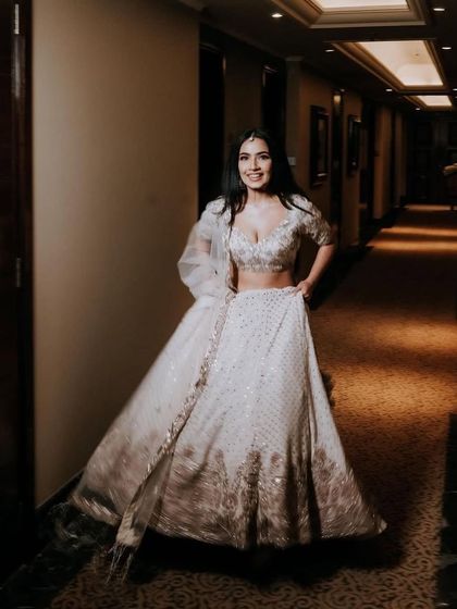 A full-length shot of the bride's beautiful engagement outfit and her elegant, understated makeup.