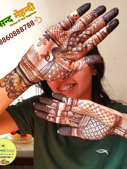 A happy client showing off her stylish mehndi design. The pattern is a modern take on traditional motifs, perfect for someone with braces and a youthful spirit.