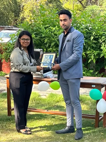 Being presented with a memento by a student organizer at the SRCC event.